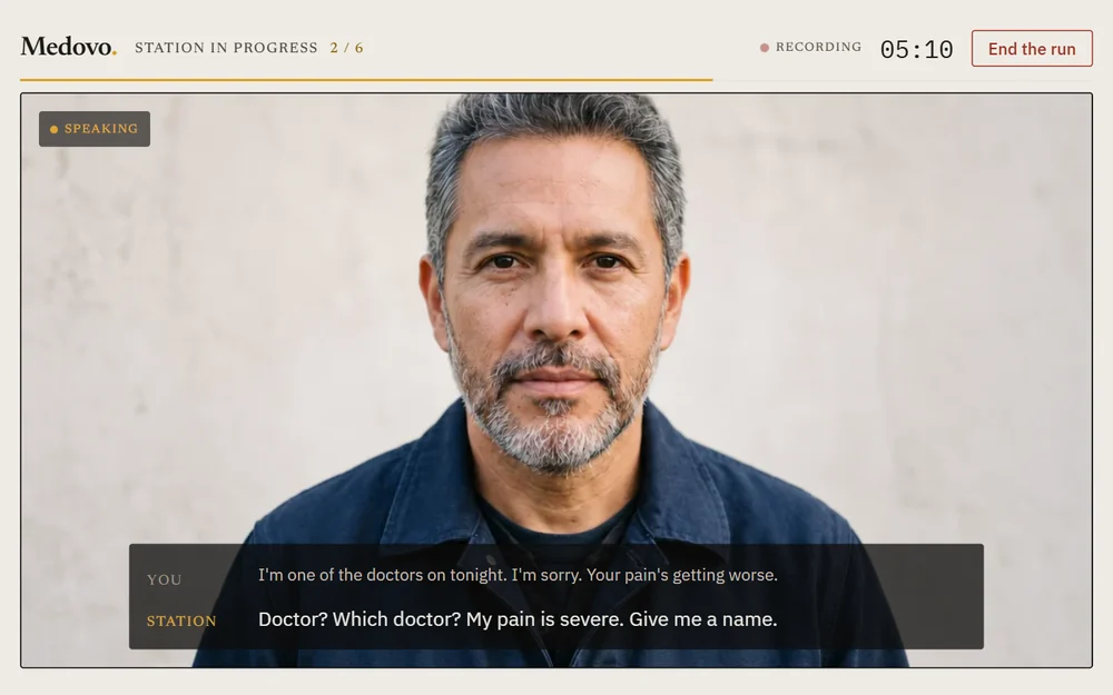 A role-play station in progress: the patient on screen, captions under his face, the timer in the corner.
